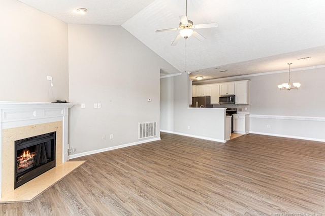 unfurnished living room featuring visible vents, light wood-style flooring, ceiling fan with notable chandelier, a premium fireplace, and baseboards