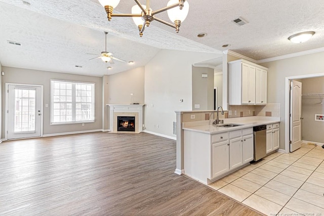 kitchen featuring a sink, visible vents, dishwasher, and light countertops