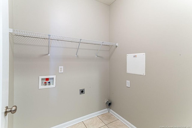 clothes washing area with baseboards, hookup for an electric dryer, laundry area, light tile patterned flooring, and washer hookup