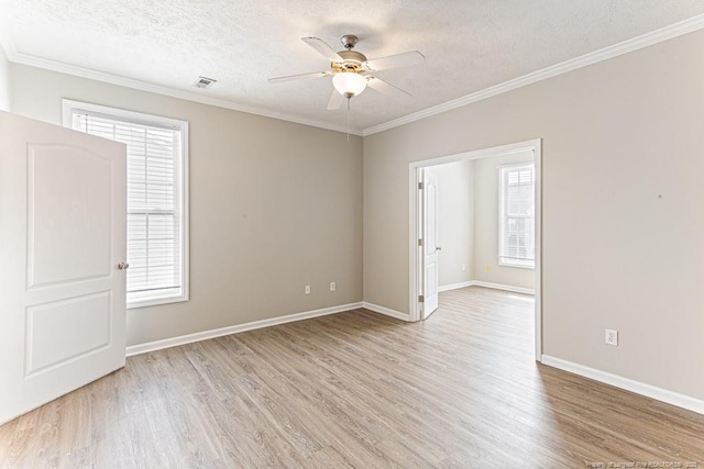 unfurnished room with light wood finished floors, a textured ceiling, ceiling fan, and ornamental molding