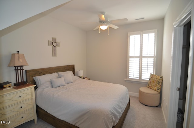 bedroom with visible vents, light colored carpet, a ceiling fan, and baseboards