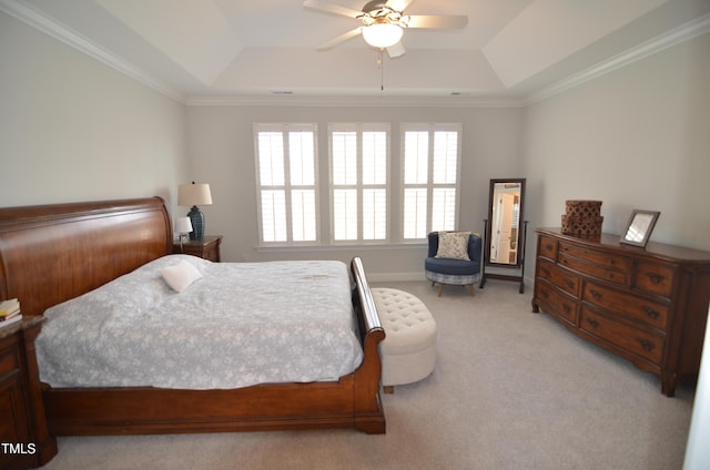 bedroom featuring ceiling fan, a tray ceiling, and light carpet