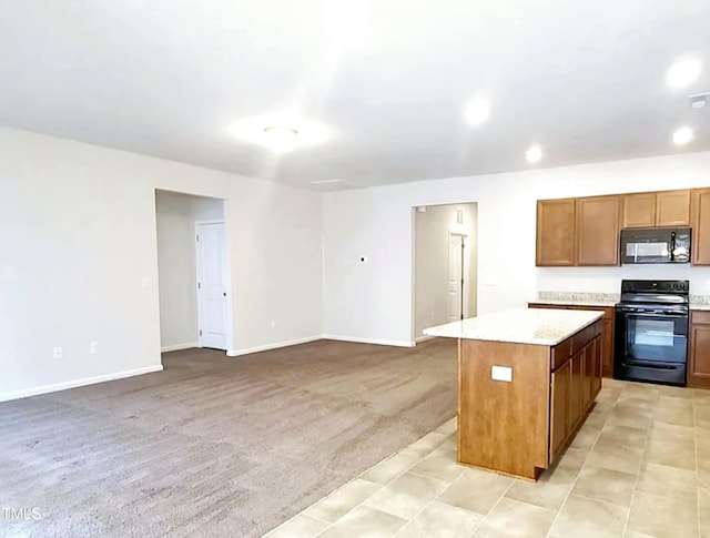 kitchen with baseboards, a kitchen island, black appliances, light countertops, and light carpet