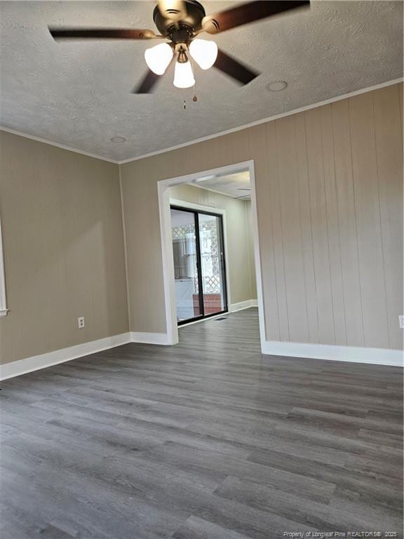 empty room featuring dark wood finished floors, a textured ceiling, crown molding, and ceiling fan