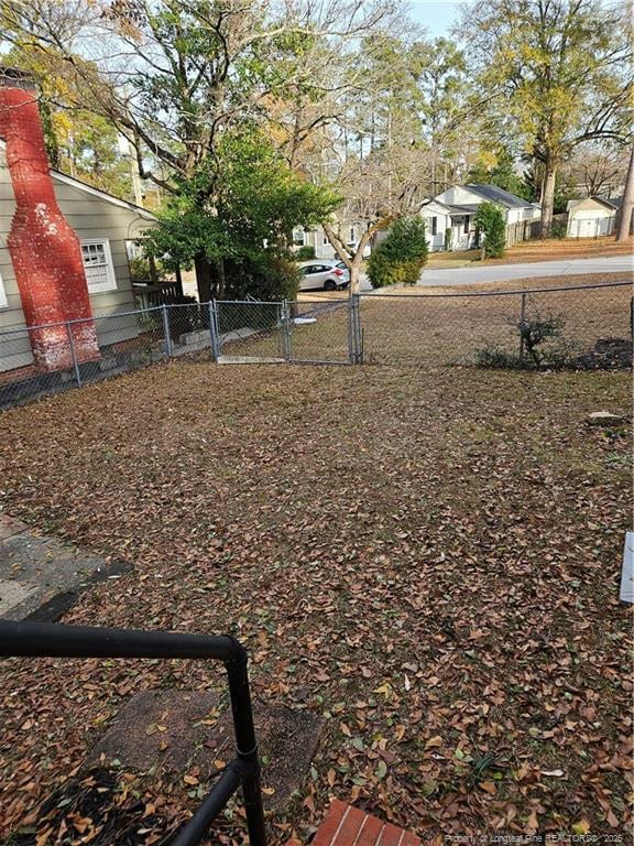 view of yard with a residential view and fence