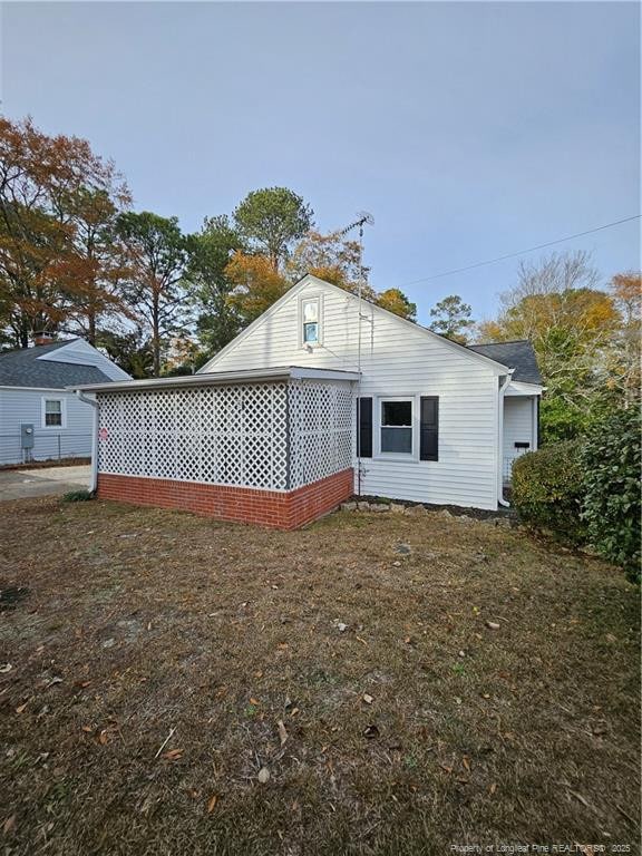 rear view of property with a lawn