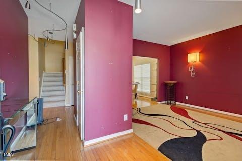 interior space featuring stairs, wood finished floors, and baseboards