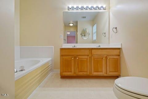 full bathroom with a bath, a sink, and double vanity