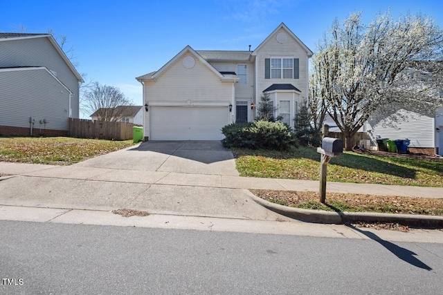 traditional home with a garage, driveway, and fence