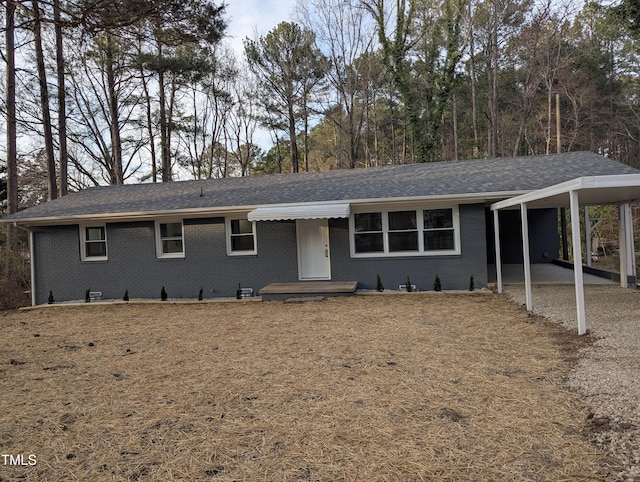 ranch-style house with a carport and brick siding