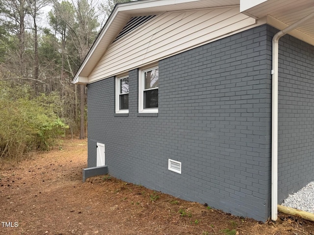 view of side of property featuring brick siding