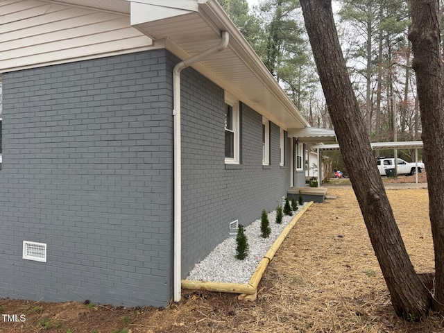 view of property exterior featuring crawl space and brick siding