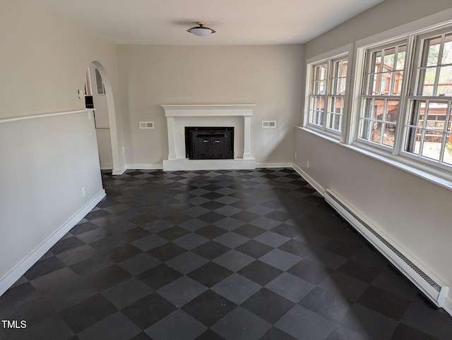 unfurnished living room with visible vents, a brick fireplace, baseboards, arched walkways, and a baseboard radiator