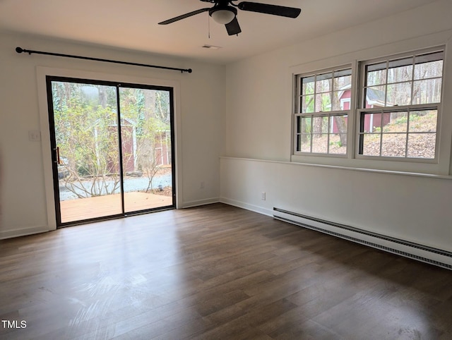 unfurnished room featuring a ceiling fan, visible vents, baseboards, dark wood-style flooring, and baseboard heating