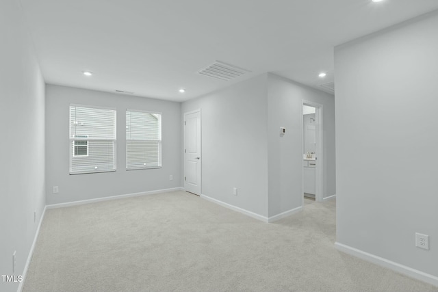 unfurnished room featuring recessed lighting, visible vents, light carpet, and baseboards