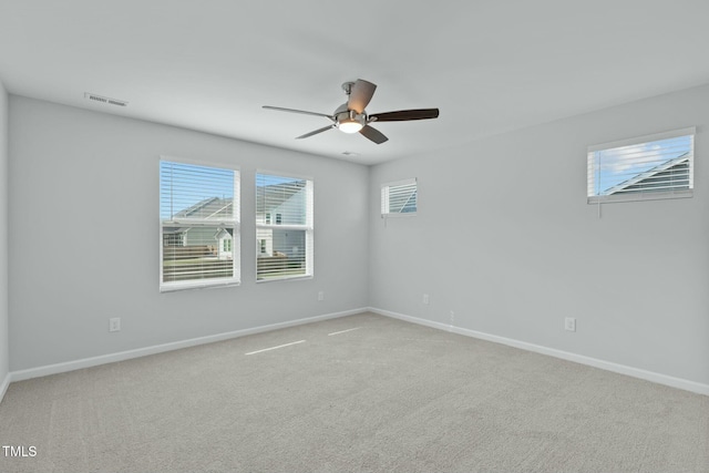 empty room featuring visible vents, baseboards, ceiling fan, and carpet flooring