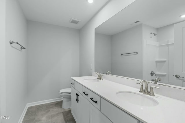 bathroom with visible vents, toilet, baseboards, and a sink