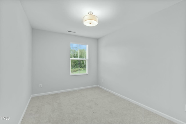 carpeted empty room with visible vents and baseboards