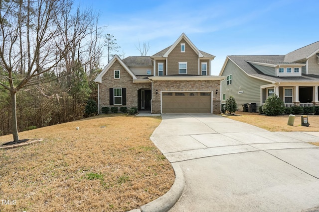 craftsman-style house featuring stone siding, driveway, an attached garage, and a front yard