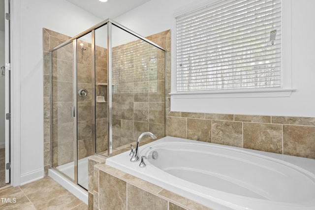 bathroom with a garden tub, a stall shower, and tile patterned flooring