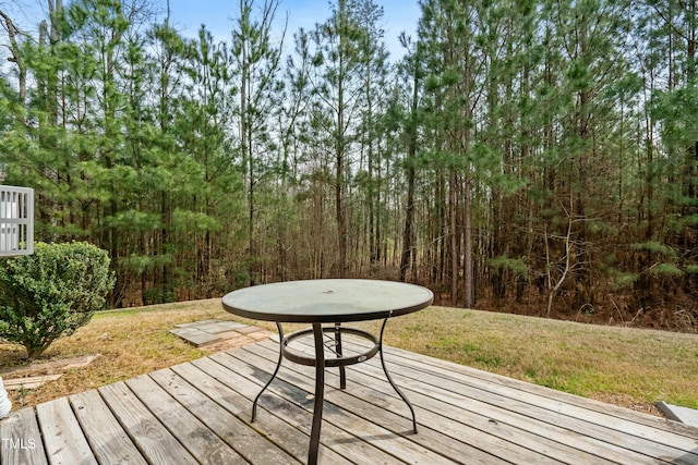 wooden terrace with a lawn