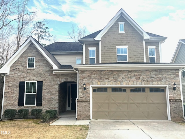 craftsman house featuring concrete driveway, an attached garage, stone siding, and roof with shingles