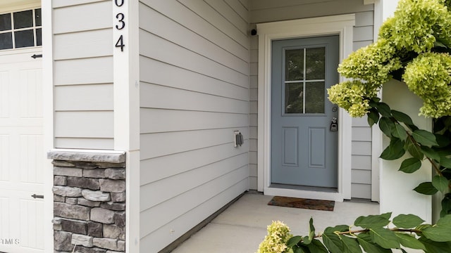 view of exterior entry featuring stone siding