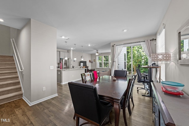 dining space featuring stairway, a healthy amount of sunlight, a ceiling fan, and wood finished floors