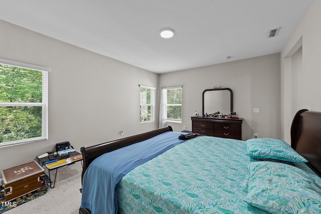 carpeted bedroom with visible vents