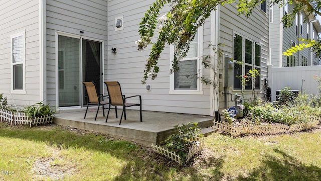 entrance to property with a patio and fence