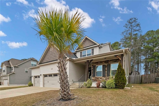 craftsman house featuring fence, concrete driveway, a front yard, a garage, and stone siding