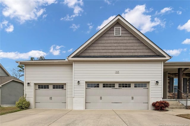 exterior space featuring concrete driveway and an attached garage