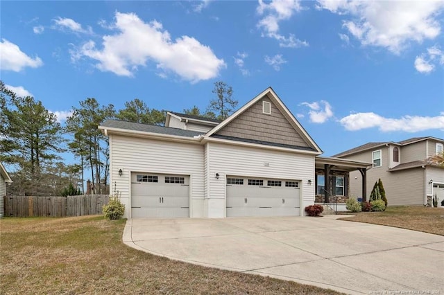 view of front of property with a front lawn, an attached garage, driveway, and fence