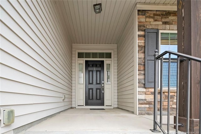 property entrance with stone siding