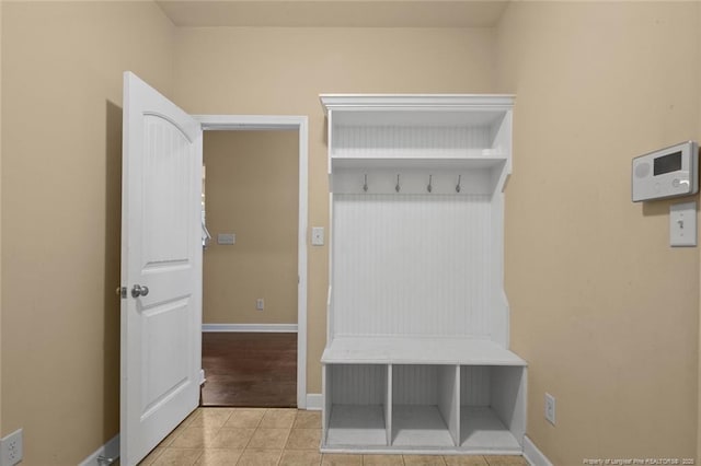 mudroom with tile patterned floors and baseboards