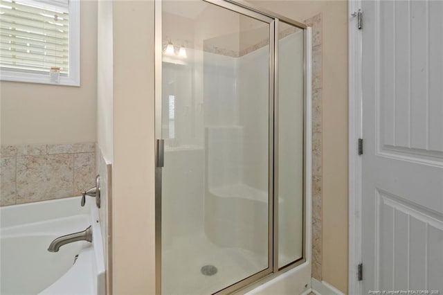 full bath featuring a garden tub and a stall shower