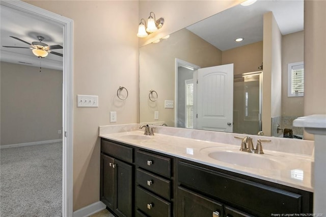 full bath featuring a sink, baseboards, ceiling fan, and double vanity