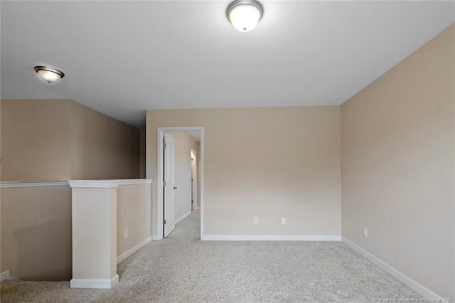 spare room featuring carpet flooring and baseboards