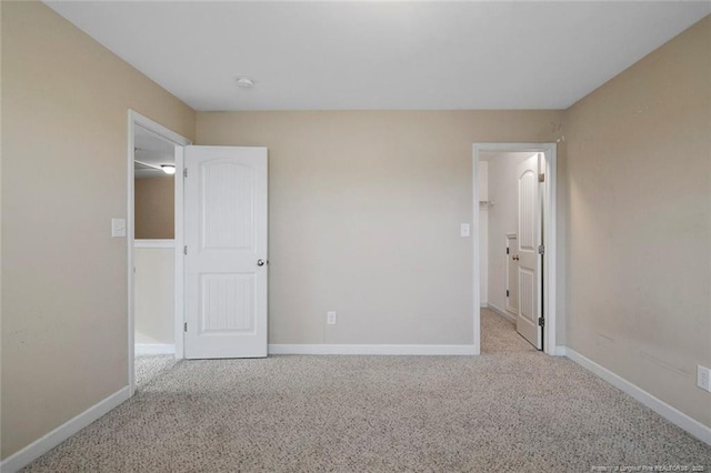 unfurnished bedroom with baseboards and carpet flooring