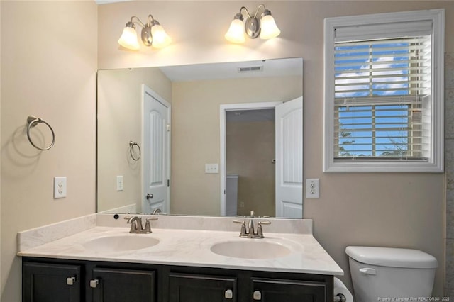 bathroom with a sink, visible vents, and plenty of natural light