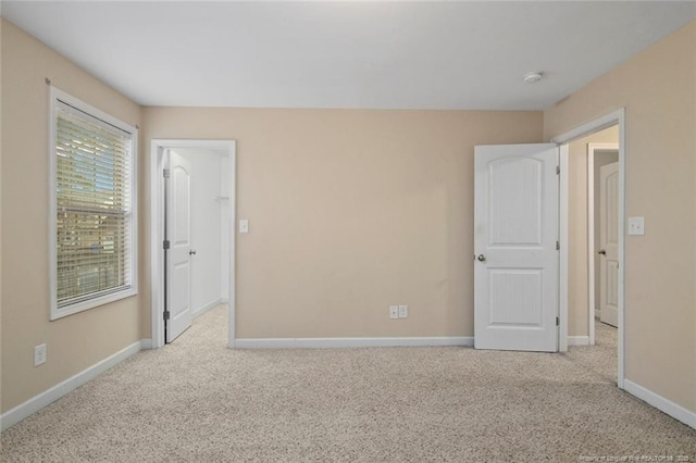 unfurnished bedroom featuring baseboards and carpet floors