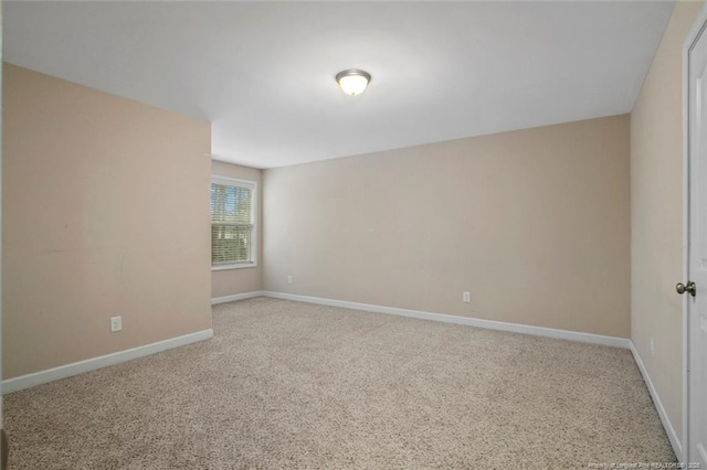 spare room with carpet flooring and baseboards