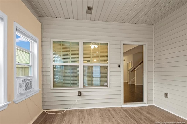 unfurnished sunroom with cooling unit and wood ceiling