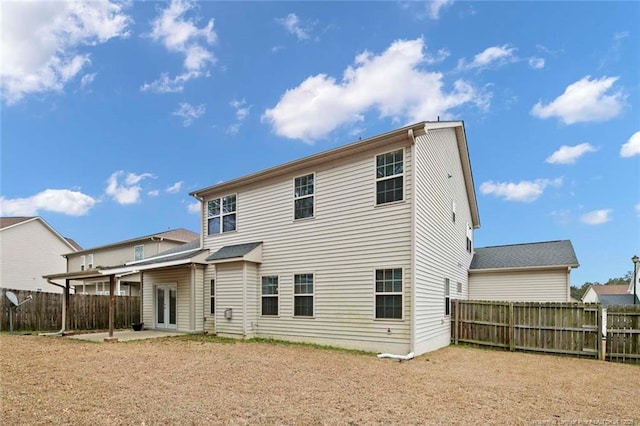 back of house featuring a patio and a fenced backyard