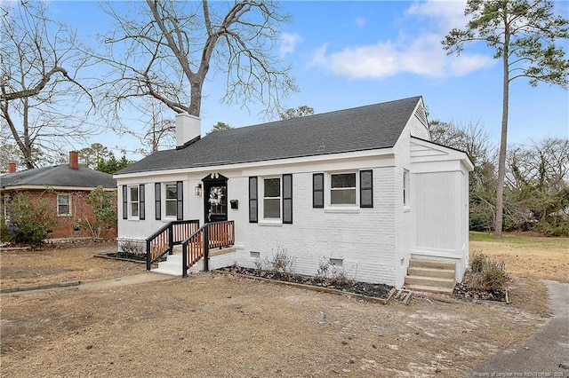 bungalow with brick siding, crawl space, a chimney, and roof with shingles