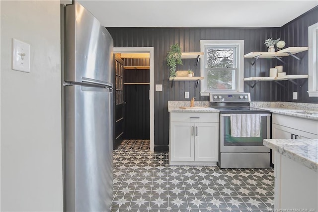 kitchen featuring light floors, white cabinets, stainless steel appliances, and open shelves