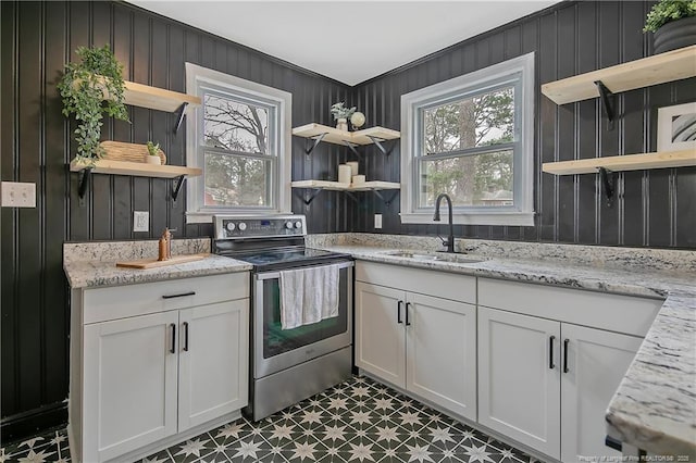 kitchen with open shelves, white cabinetry, stainless steel electric range, and a sink