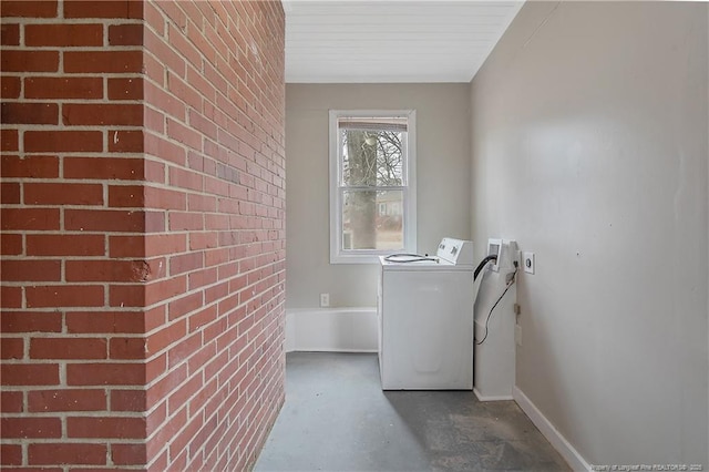 clothes washing area featuring laundry area, washer / dryer, and baseboards