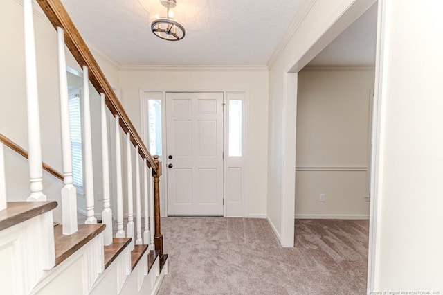 entrance foyer featuring stairs, ornamental molding, and light carpet