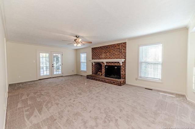 unfurnished living room featuring ornamental molding, baseboards, carpet floors, and ceiling fan